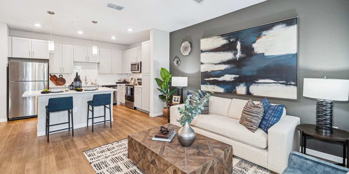 Open-concept living room and kitchen at Savelle Nona West with modern finishes and island seating.