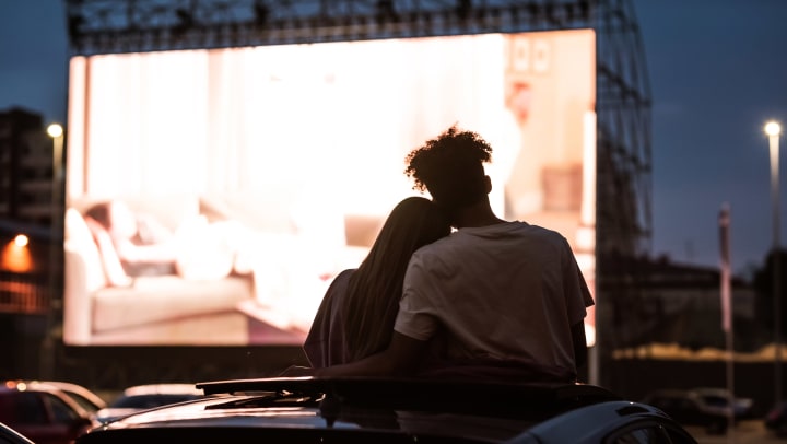 A couple hugging while watching a movie at a Herriman drive-in theater.