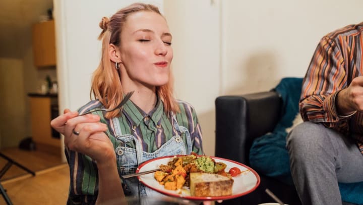 Woman enjoying a delicious meal with friends at home