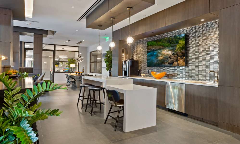 Clubhouse bar and drink area with coffee machines and lots of seating at 6600 Main in Miami Lakes, Florida