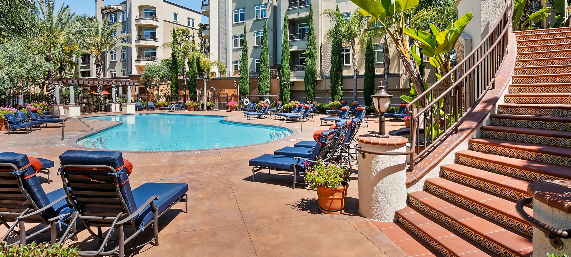 Luxurious pool side patio with sun chairs at Playa Del Oro, Los Angeles, California