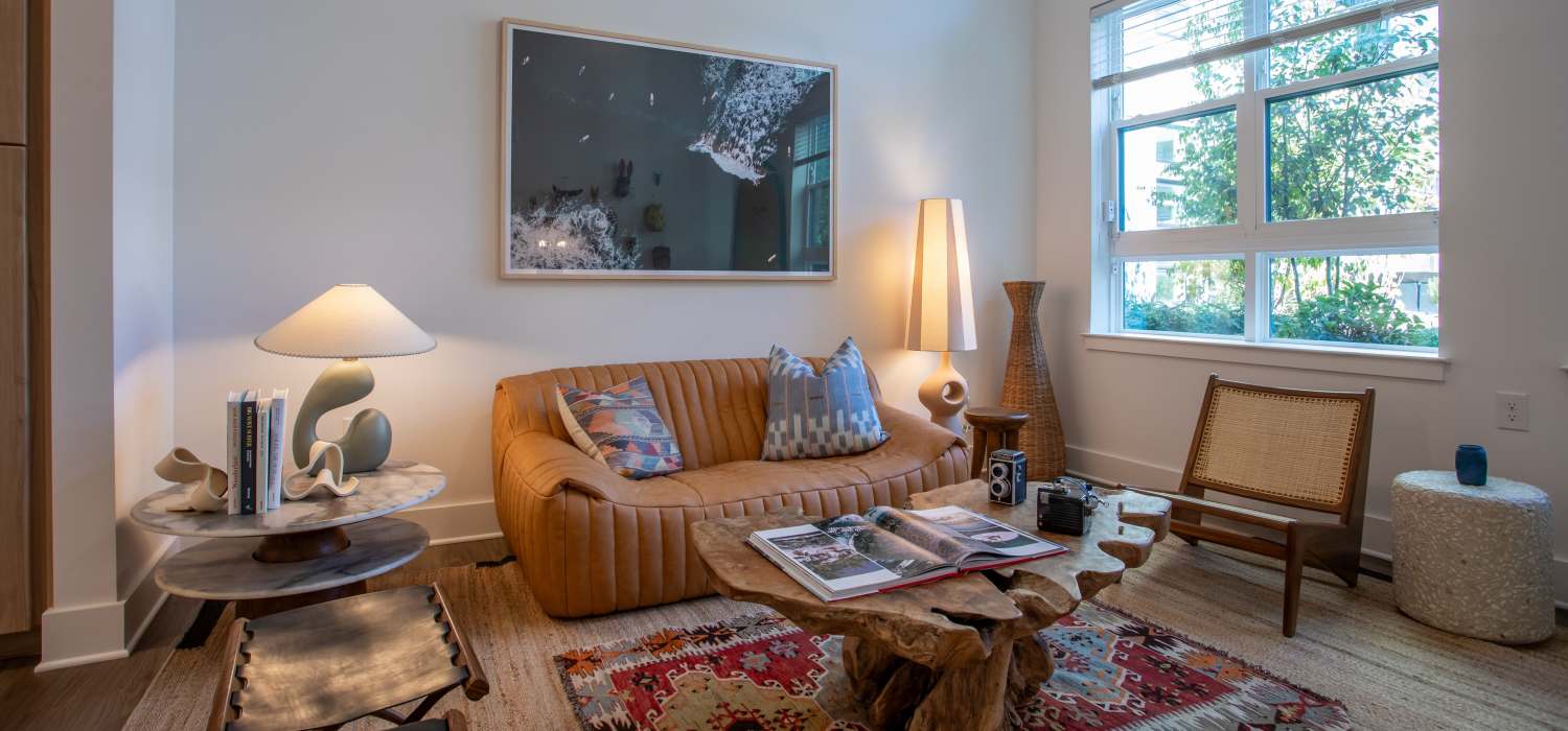 Bright living room with large windows at St. Albans Lofts in Raleigh, North Carolina