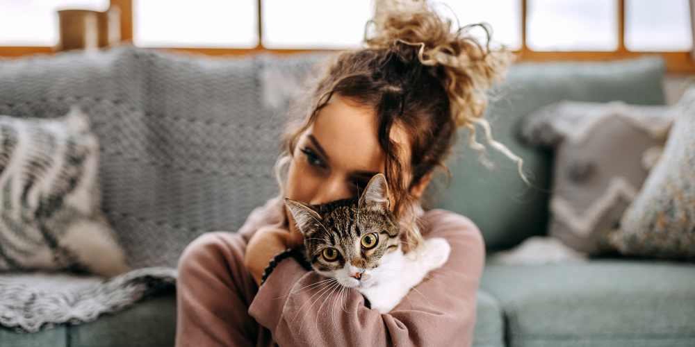  Resident cuddling cat in the pet-friendly community atVivo Living Charlotte in Charlotte, North Carolina
