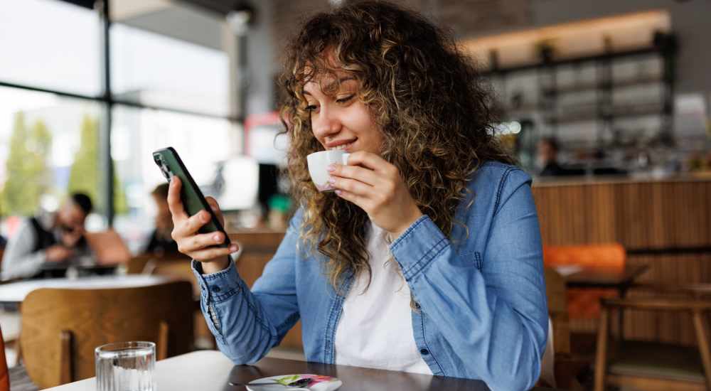 Woman having a cup of coffee in a restaurant near Tapestry on Vaughn in Montgomery, Alabama