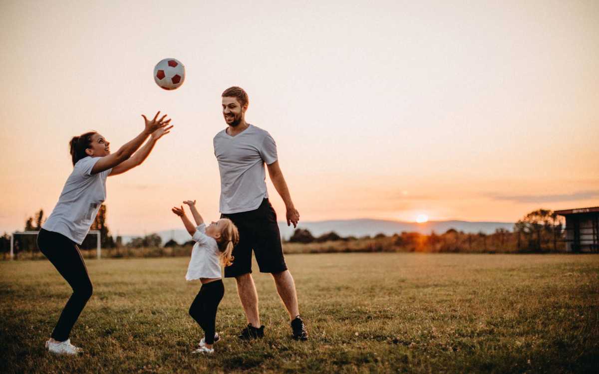 Resident family playing with a ball near Fulton Hill Apartments in Tallahassee, Florida
