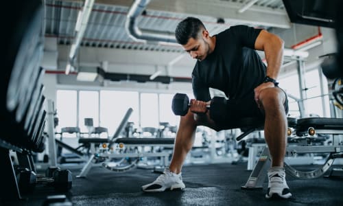 Lifting weights in the fitness center at Washington Townhomes in San Lorenzo, California