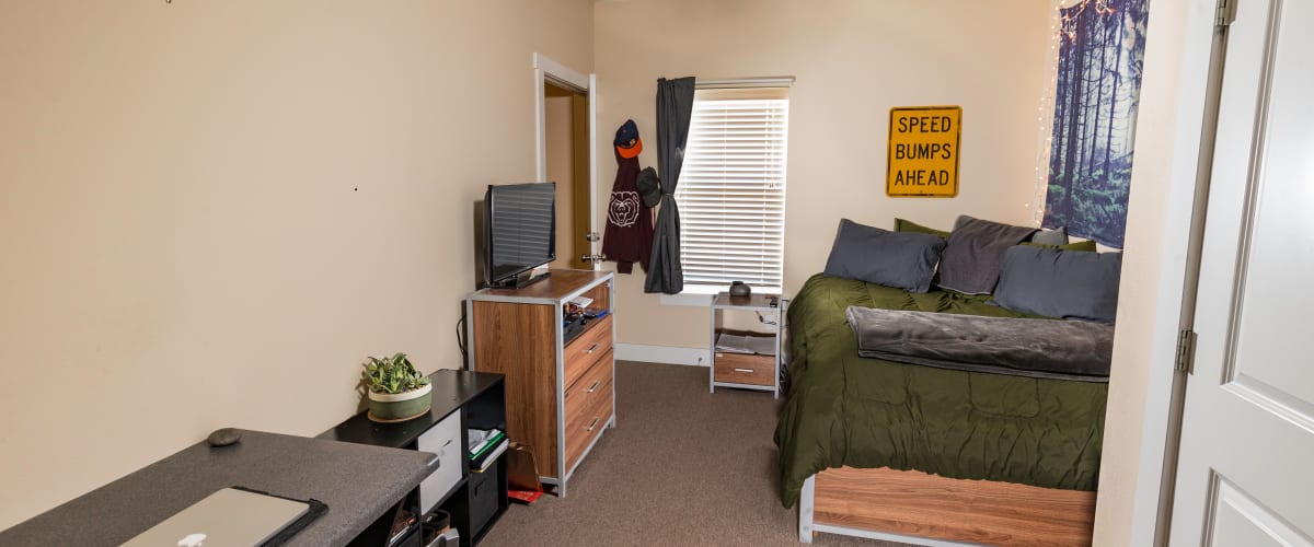 A large bedroom with room to study at Beacon Springfield in Springfield, Missouri