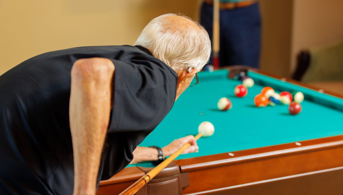 Resident playing pool at Touchmark at Meadow Lake Village in Meridian, Idaho