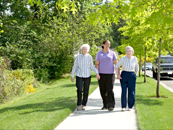 Two residents and a staff member out for a walk near Patriots Landing in DuPont, Washington. 