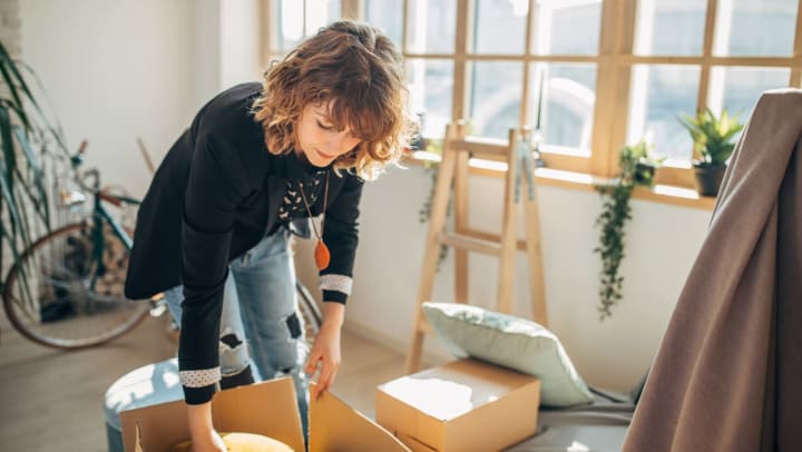 Resident packing up some things to get rid of in her apartment home at The Slate in Savannah, Georgia 