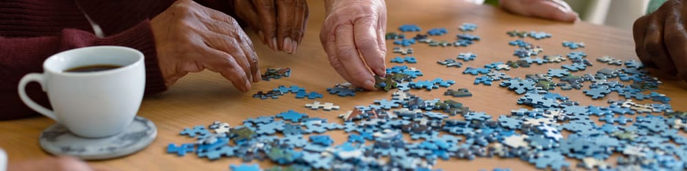 Residents doing a puzzle at The Heritage Memory Care in The Woodlands, Texas