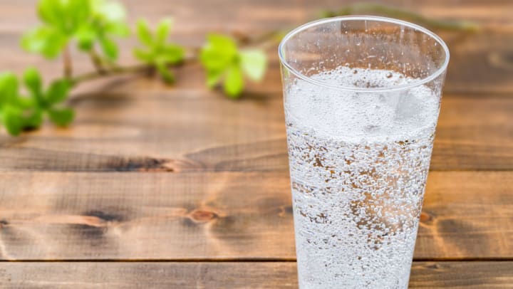 Carbonated water on wood grain background