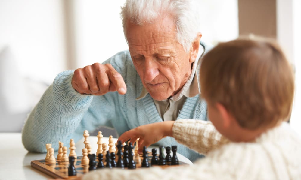 A resident and a child playing a game of chess at Amaran Senior Living in Albuquerque, New Mexico. 