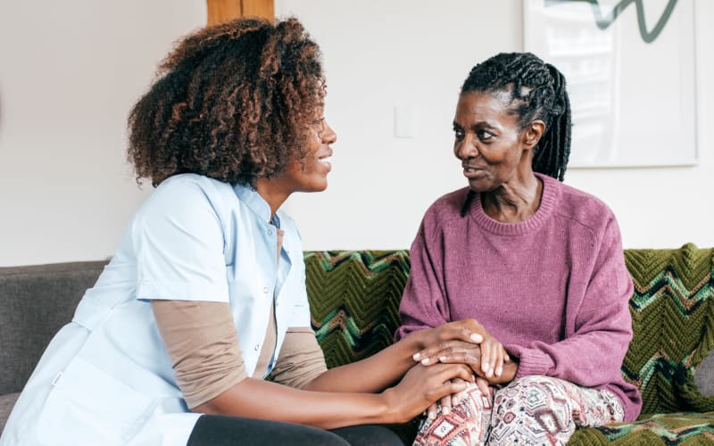 Staff member talking with a resident at Grand Villa of Clearwater in Clearwater, Florida