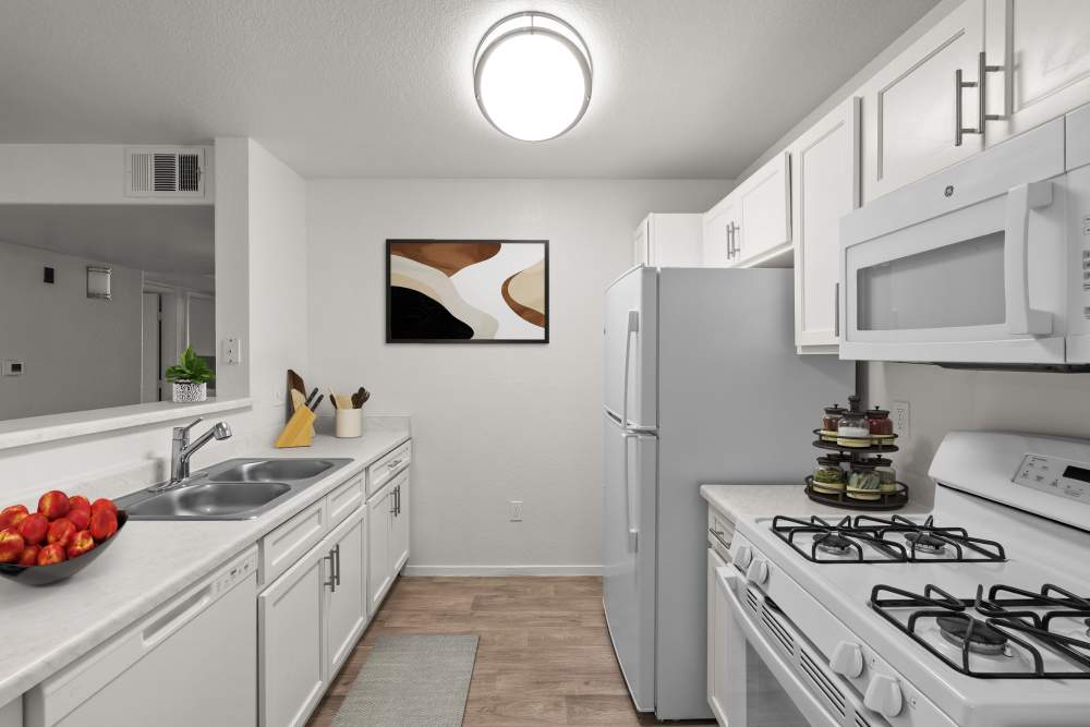 Modern kitchen with white cabinets and appliances at Zephyr Pointe in Reno, Nevada 