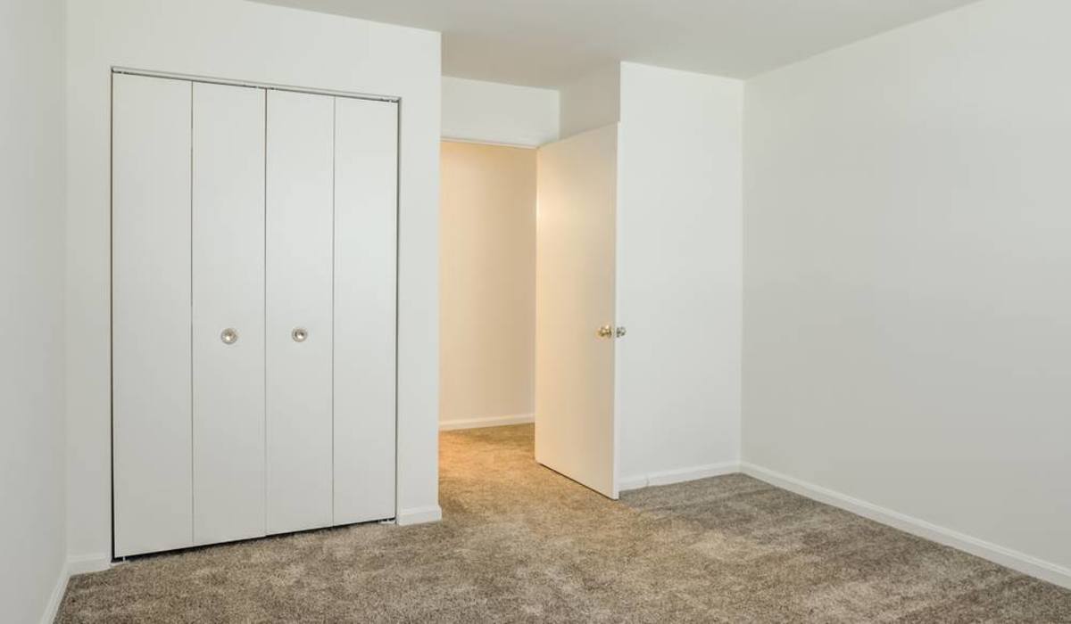 White closet with a door at The Vinings at Christiana Apartments in Newark, Delaware