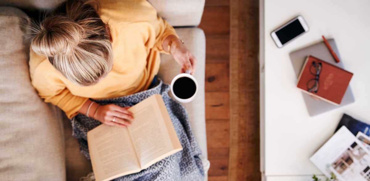 A resident sips coffee and reads a book at Mason Avenue, Alexandria, Virginia