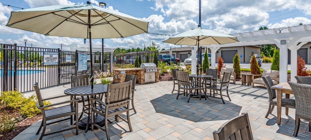 Awesome lounge sundeck area with chairs and umbrellas at Flats At 540 in Apex, North Carolina