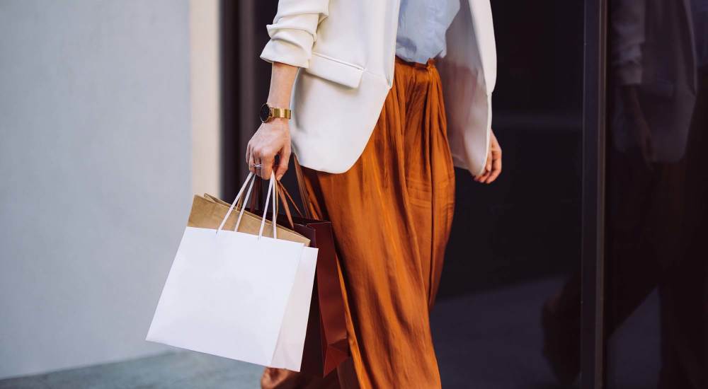 Resident doing shopping near The Boulevard Apartment Homes in Woodland Hills, California