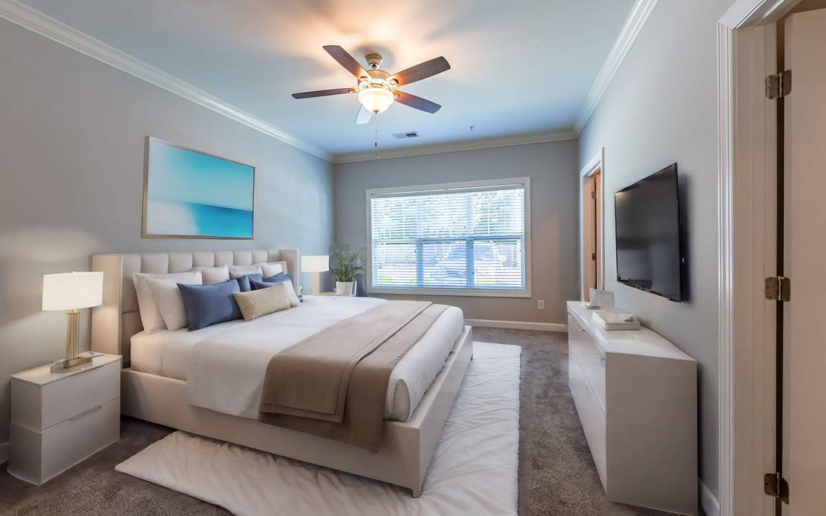 Model bedroom with window at Amelia Apartments in Fayetteville, North Carolina