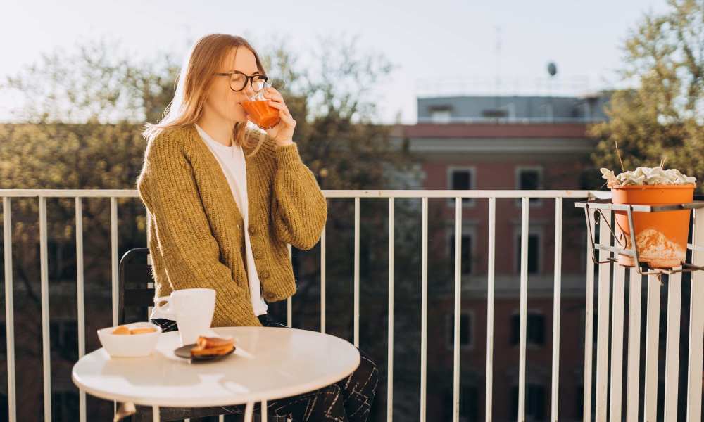 Resident enjoying her coffee and the scenery from the balcony at Willow Creek Villas in Sparks, Nevada