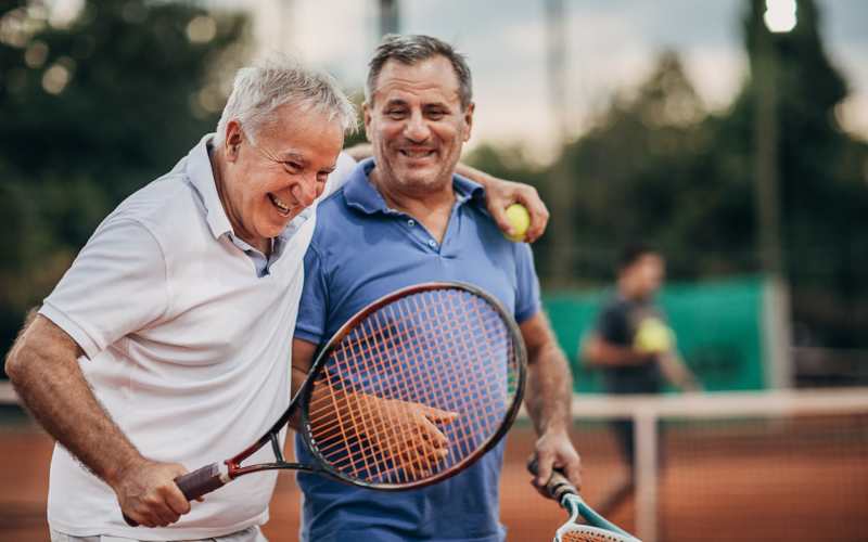 Senior resident playing tennis at Grand Villa of Ocala in Ocala, Florida