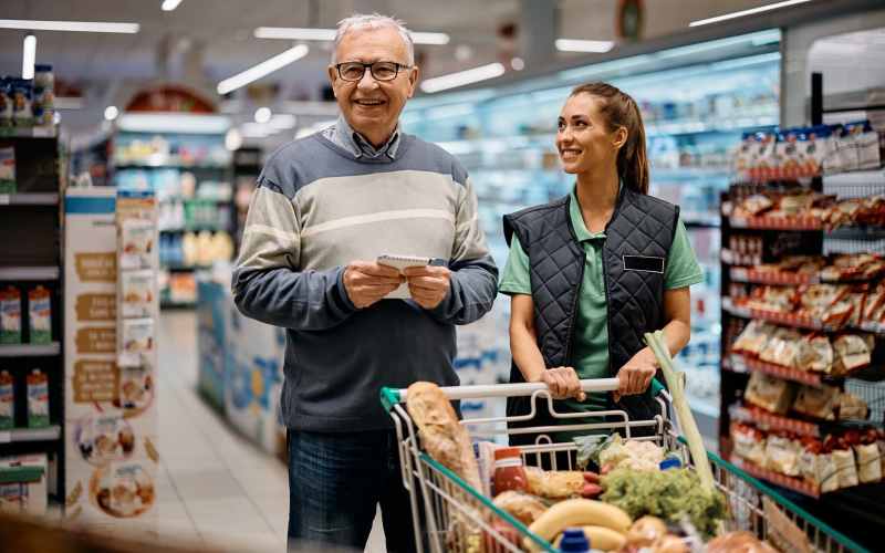 caregiver helping senior resident for grocery shopping at Grand Villa of Ocala in Ocala, Florida