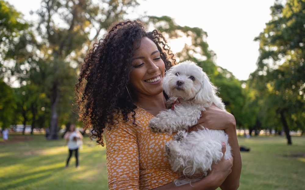 Resident with her dog in the park at The Commons in Cincinnati, Ohio