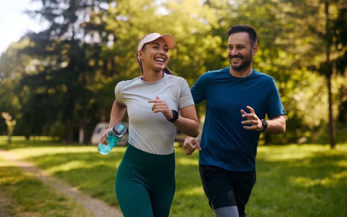 Resident couple jogging in a park at Signal Hill Apartments in Mechanicsville, Virginia