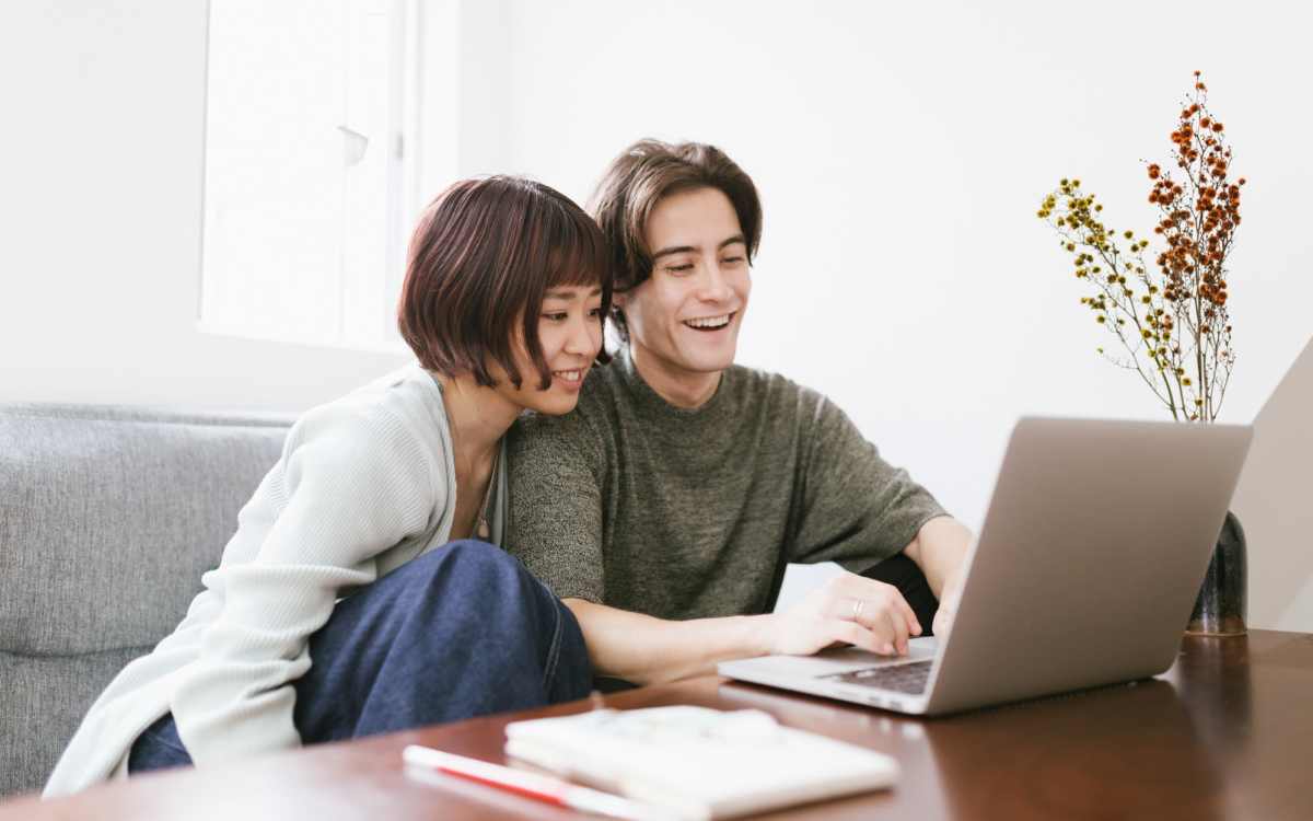 Resident couple working laptop at Woodland Apartments San Antonio in San Antonio, Texas