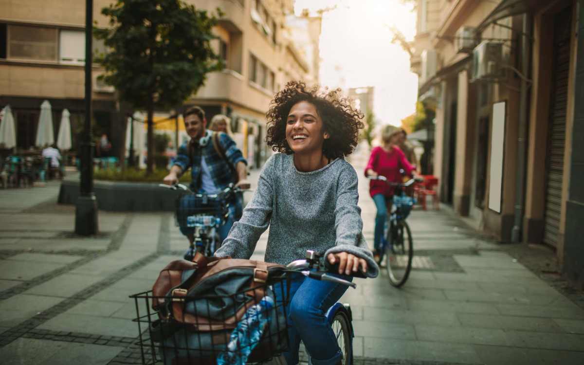 Residents riding bicycle in street near Mosaico Family Housing in Burien, Washington