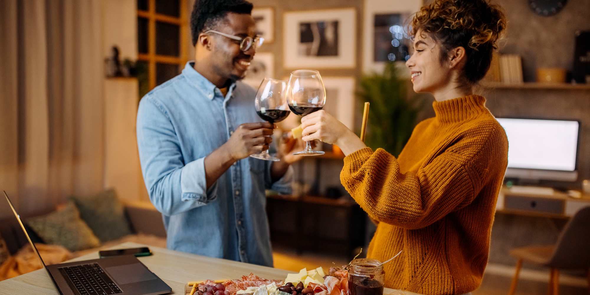 A couple holding their wine glasses together in their apartment at Copper Range in Colorado Springs, Colorado