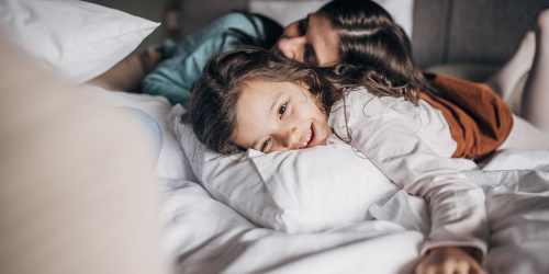 A mother and daughter laying in bed at Villa Creek in Santa Rosa, California