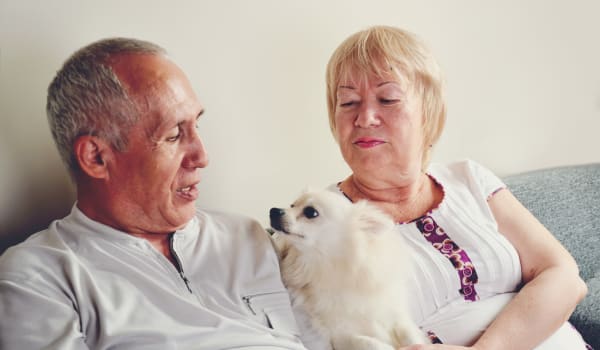 Senior couple with their small dog at Elk Meadows Assisted Living and Memory Care in Oakley, Utah