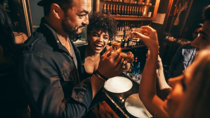 People having fun while drinking shots at a nightclub.