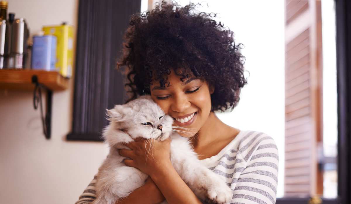 Resident holding her pet cat near Pheasant Run Townhomes in Harrisonburg, Virginia