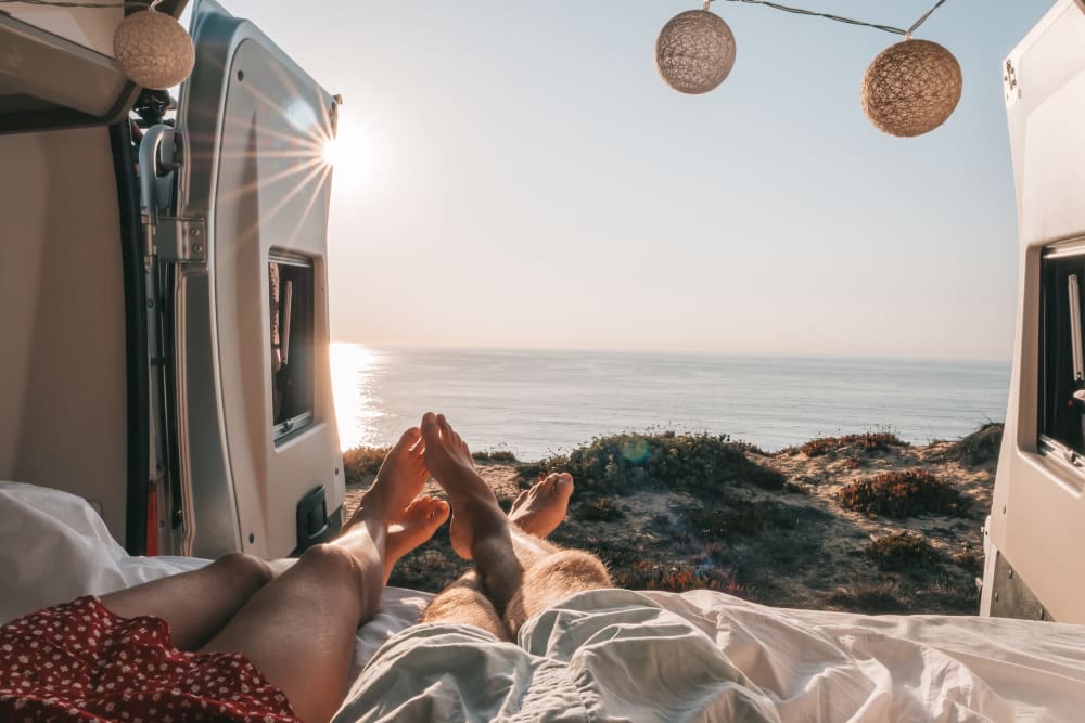 A couple laying in the back of their RV looking at water near BestBox Storage - Red Lodge in Red Lodge, Montana
