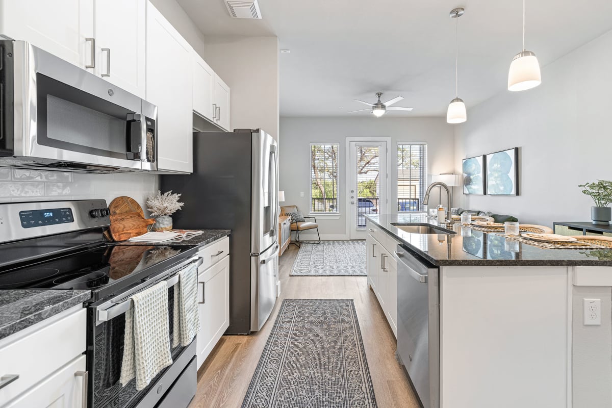 Model kitchen with modern appliances at The Gabriel in Leander, Texas
