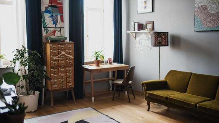 Stylish living room with a green couch and desk | apartment living room upgrades