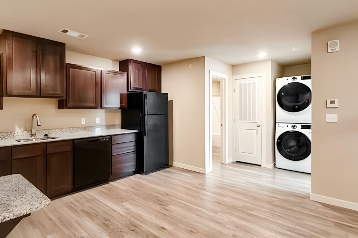 Kitchen and stacked washer and dryer at Atlas at Cabot in Cabot, Arkansas