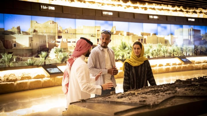 Father and daughter looking at an exhibit in a museum