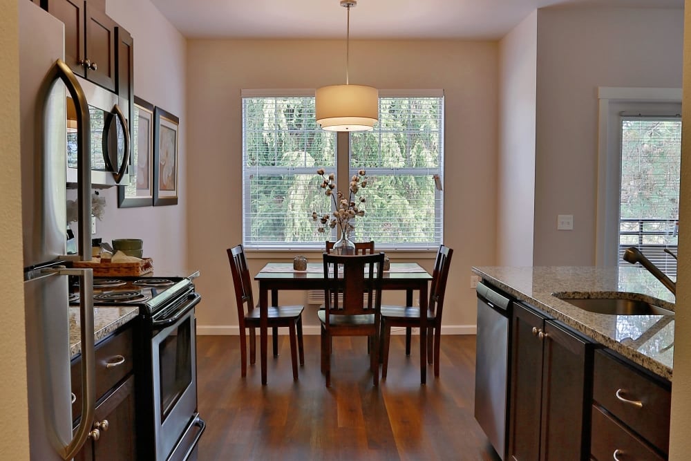 View of the dining table and kitchen at The Fairway Apartments in Salem, Oregon