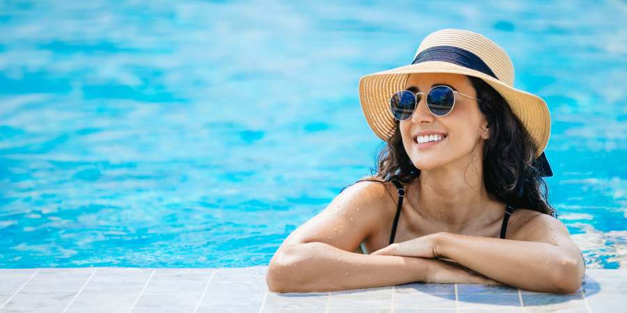 Resident relaxing in the pool at Parkwood Oaks in Bedford, Texas