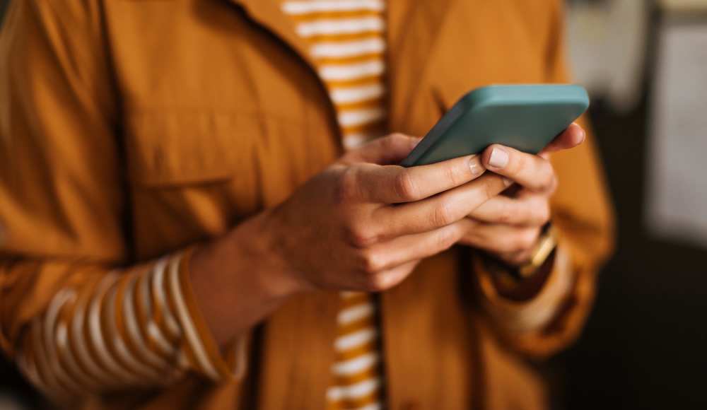 Resident holding a phone at Parkwood Manor in Norfolk, Virginia