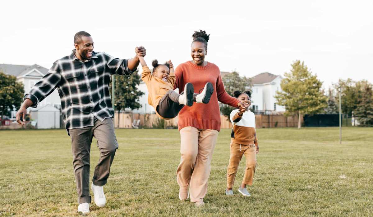 A family playing in a park near Copper Steppe in Parker, Colorado