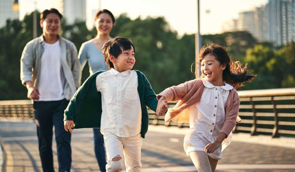 Happy family exploring neighborhood near Walnut Apartments in Philadelphia, Pennsylvania