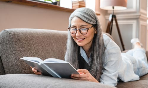 Resident reading in her apartment at Washington Townhomes in San Lorenzo, California