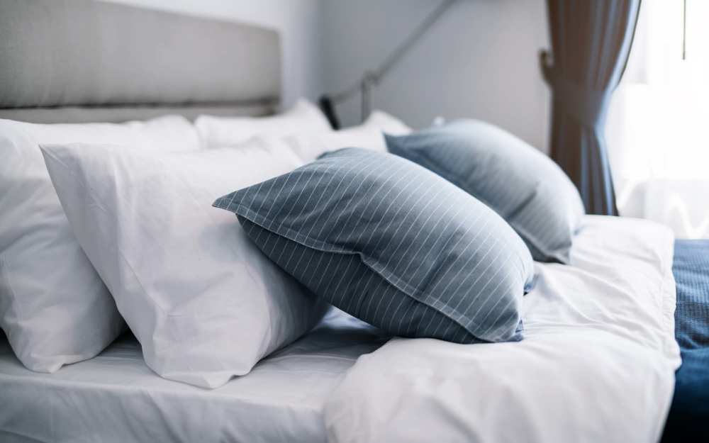 Bedroom with blue cushions and a window at Winchester Run in Oklahoma City, Oklahoma