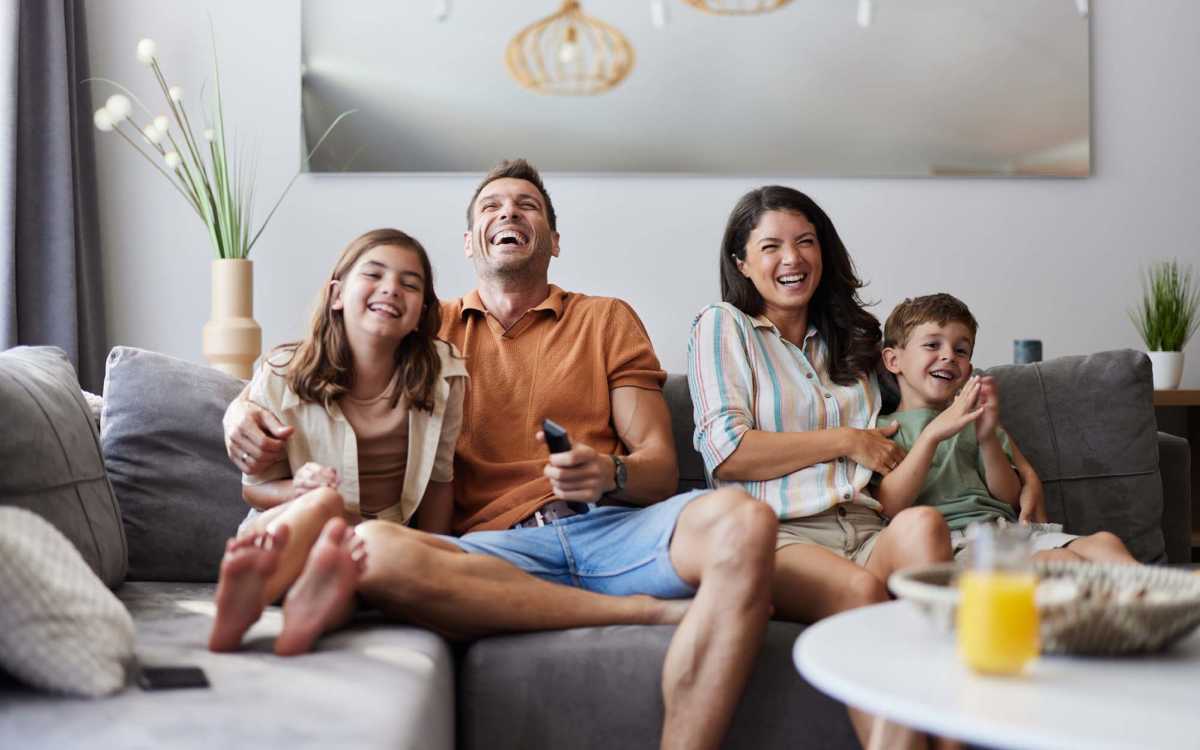Family enjoying in their living room at Devonwood Apartments in Fayetteville, North Carolina