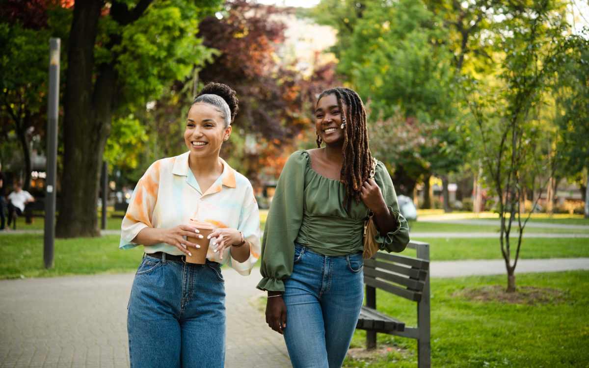 Residents walking through a park near Cross Creek in Laurel, Maryland